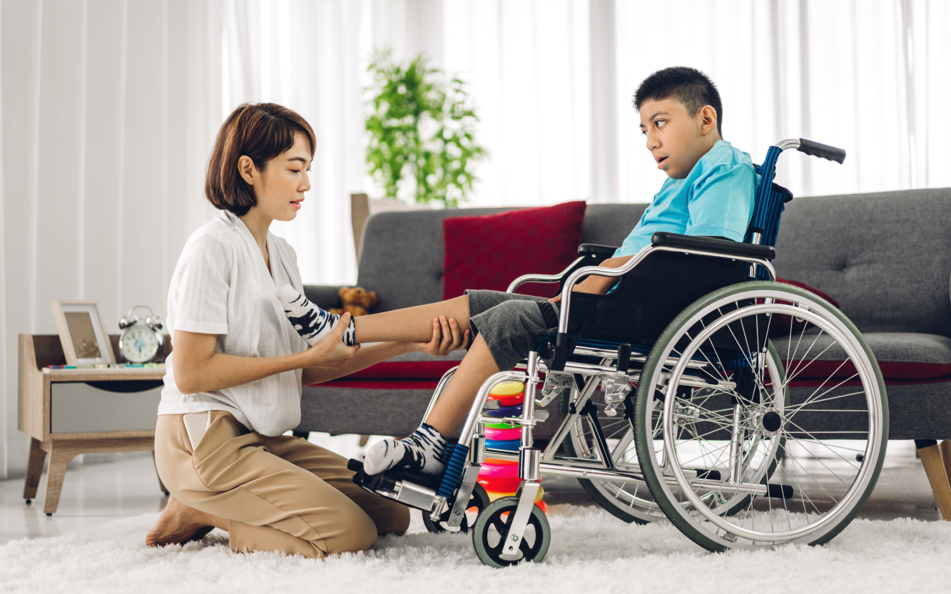 portrait-asian-physiotherapist-carer-helping-playing-with-special-disabled-child-health-problem-by-doing-exercises-sitting-wheelchair-rehabilitation-clinic-disability-care-concept 1